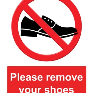 May include: A sign showing a black shoe crossed out by a red circle, with the text "Please remove your shoes" in a red rectangle below. The sign is on a white background.