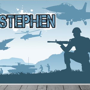 May include: A blue and gray military themed backdrop with the name "STEPHEN" in large, bold letters. The backdrop features silhouettes of military vehicles, soldiers, and aircraft.