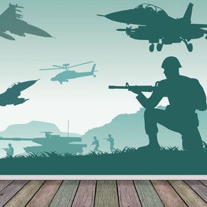 May include: A green and blue camouflage wallpaper with a silhouette of a soldier holding a rifle, a tank, and several airplanes. The wallpaper is set against a wooden floor.