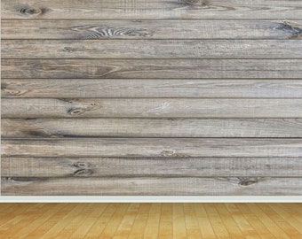 May include: A wood-paneled wall with a white baseboard and a light brown wood floor.