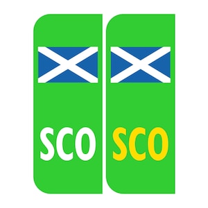 May include: Two green rectangular signs with the word "SCO" in white and yellow letters. Each sign features a blue and white Scottish flag.