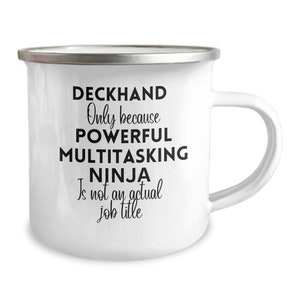 May include: White enamel mug with a silver rim and a white handle. The mug features black text that reads "DECKHAND Only because POWERFUL MULTITASKING NINJA Is not an actual job title."