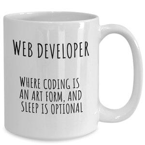 May include: White ceramic mug with the text "WEB DEVELOPER" above the phrase "WHERE CODING IS AN ART FORM, AND SLEEP IS OPTIONAL" in black lettering. The mug has a curved handle.