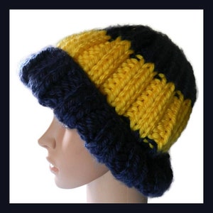 May include: A blue and yellow crocheted beanie hat. The hat has a wide brim and is made with thick yarn.