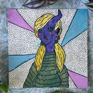 May include: A colorful illustration of a person with purple skin, blonde hair, and a single horn. The person is wearing a green sweater and earrings. The background features a dotted pattern with pink and blue rays.