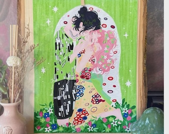 May include: A framed art print featuring a couple embracing, inspired by Gustav Klimt's "The Kiss." The artwork has a green background with floral and star accents. The couple is depicted with black and pink hair, wearing colorful clothing.