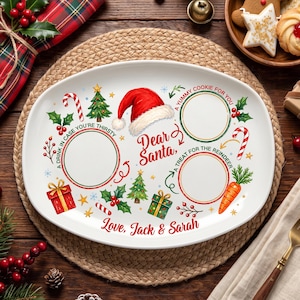 May include: An oval white ceramic plate featuring a red Santa hat, Christmas trees, holly, gifts, and candy canes. It includes three circular areas labelled A YUMMY COOKIE FOR YOU, A DRINK IN CASE YOU'RE THIRSTY, and A TREAT FOR THE REINDEER, with Dear Santa and Love, Jack & Sarah printed in red.