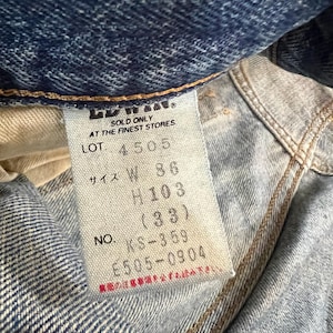 May include: Close-up of a denim jeans label with text. The label reads "SOLD ONLY AT THE FINEST STORES" and includes size information: W 36, H 103 (33). The label also shows the lot number 4505 and the number KS-359.