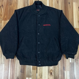 May include: A black wool bomber jacket with a red embroidered HONDA logo on the front. The jacket has a ribbed collar, cuffs, and waistband.