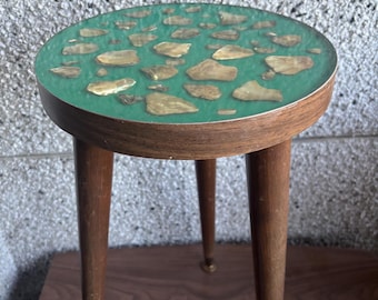 Taburete vintage de mediados de siglo con tapa de concha color turquesa.
