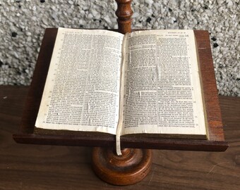 vintage faux Bible on wooden stand with candle holder