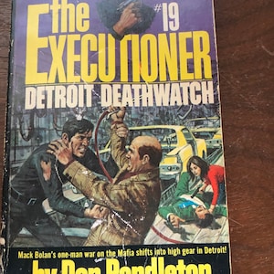 May include: Vintage paperback book titled "The Executioner: Detroit Deathwatch" by Don Pendleton. The cover features a dramatic illustration of a man with a gun, and other figures in a fight scene. The book is number 19 in the series.