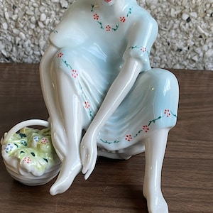 Vintage porcelain woman with flower basket