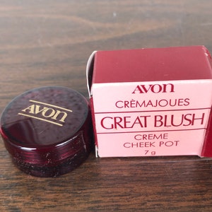May include: A red and gold Avon Creme Cheek Pot labeled "Great Blush" with a 7g size.