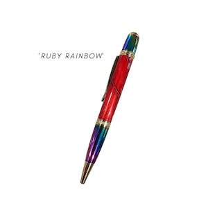 May include: A red and iridescent pen with gold accents. The pen is labelled 'RUBY RAINBOW'.