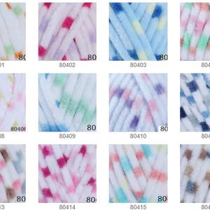 May include: A selection of yarn skeins in various colours. Each skein is white with a pattern of coloured dots. The colours include green, orange, pink, blue, and brown. The number "80" is printed on each skein, along with a product code.