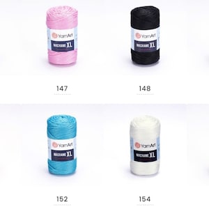 May include: Assortment of ten spools of macrame cord in various colors, including burgundy, pink, black, gray, brown, teal, white, and gold. Each spool is labeled "YarnArt Macrame XL".