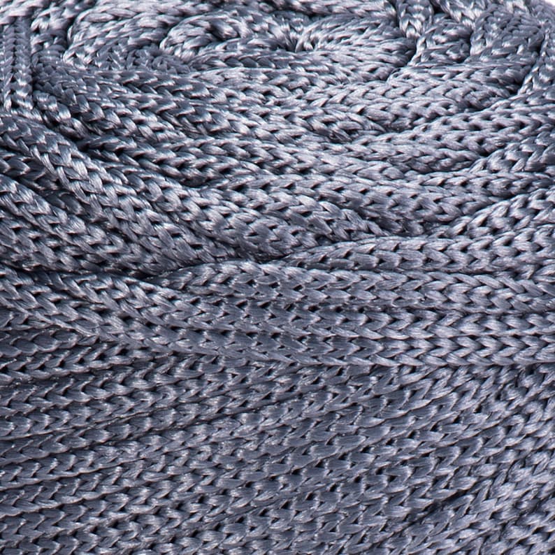 May include: Close-up of a coiled gray rope with a braided texture.
