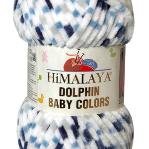 May include: A ball of Himalaya Dolphin Baby Colors yarn. The yarn is a soft, plush material in white with a pattern of blue and grey squares. The label reads "Himalaya Dolphin Baby Colors".
