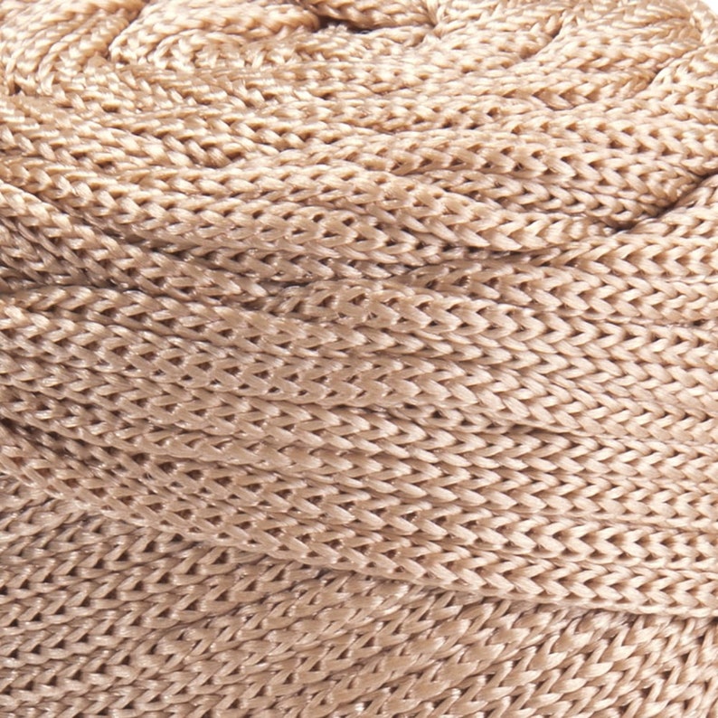 May include: A close-up of a beige braided rope, showing the intricate woven pattern.