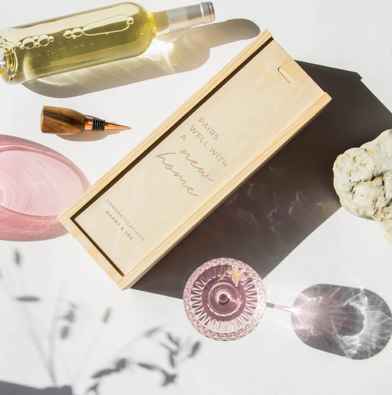 May include: Wooden wine box with the text "Pairs well with a new home" and the names "Congratulations Mary & Joe".
