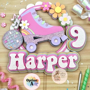 May include: A layered cake topper with a pink roller skate, rainbow, flowers, and a disco ball. The name "Harper" is displayed in glittery letters. A number 9 is also included, suggesting a birthday theme.