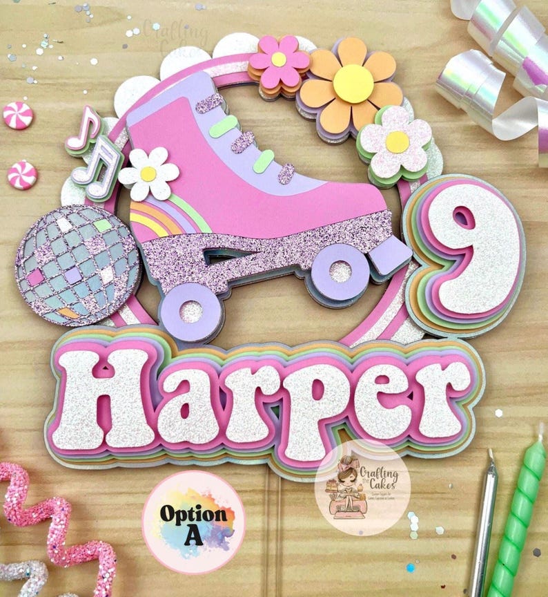 May include: A layered cake topper with a pink roller skate, rainbow, flowers, and a disco ball. The name "Harper" is displayed in glittery letters. A number 9 is also included, suggesting a birthday theme.