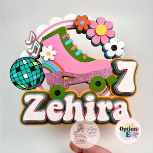 May include: A colorful cake topper featuring a pink roller skate with glitter accents, flowers, and a disco ball. The name "Zehira" and the number "7" are prominently displayed. The design has a retro theme.