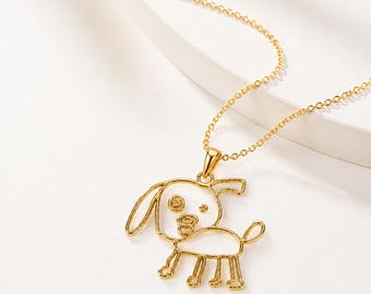 Könnte beinhalten: Eine goldfarbene Halskette mit einem Anhänger in Form einer einfachen Strichzeichnung eines Hundes. Der Anhänger ist innen hohl und hängt an einer zarten goldfarbenen Kette. Das Design zeigt einen stilisierten Hund mit Schlappohren und Schwanz.