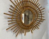 A rare find. An unusual sunshine mirror, made from rattan. 1950 s mid century modern. Extremely attractive piece.