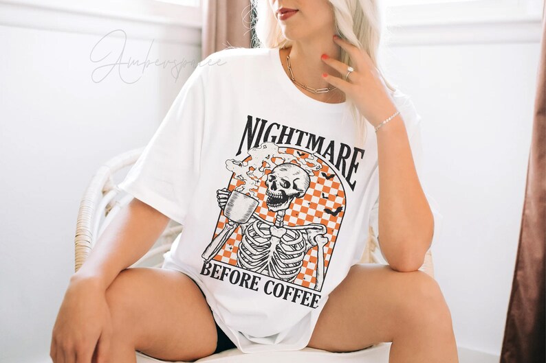 May include: White t-shirt with a graphic of a skeleton drinking coffee and the text "Nightmare Before Coffee".