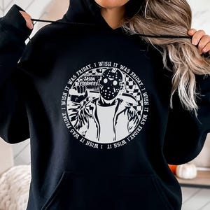 May include: Black hoodie with a white graphic print of a hockey mask wearing character holding a knife. The graphic has the text "I wish it was Friday, I wish it was Friday, I wish it was Friday, I wish it was Friday" around the character. The text "Jason Voorhees" is printed above the character.