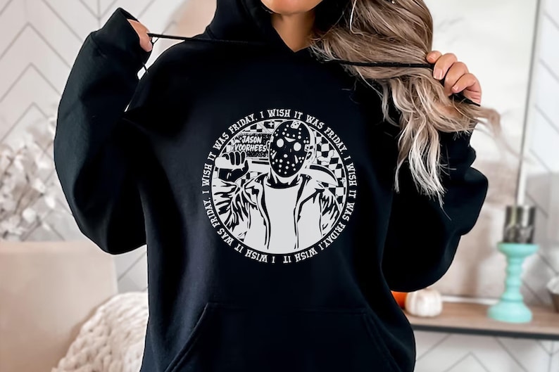 May include: Black hoodie with a white graphic print of a hockey mask wearing character holding a knife. The graphic has the text "I wish it was Friday, I wish it was Friday, I wish it was Friday, I wish it was Friday" around the character. The text "Jason Voorhees" is printed above the character.