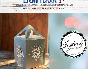 May include: A gray paper lantern with a snowflake design cut into the sides. The lantern has a handle and is sitting on a wooden surface. Text on the image reads "LIGHTBOX SVG" and "Instant Download."