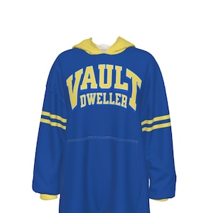 May include: A blue hooded sweatshirt with the text "VAULT DWELLER" in yellow block letters. The sweatshirt has yellow accents on the hood and sleeves, with two yellow stripes on each sleeve. A large front pocket is visible.