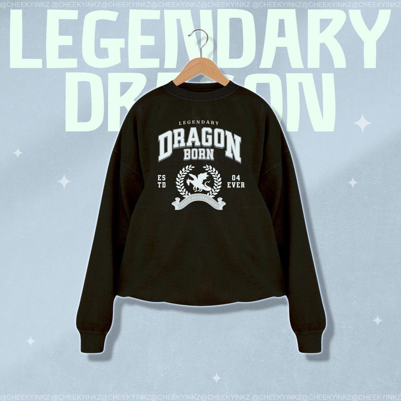May include: Black cropped sweatshirt with a white graphic print of a dragon with the text "Legendary Dragon Born" and "Est. 04 Ever".