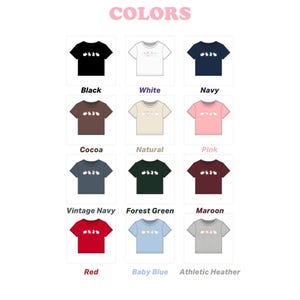 May include: A collection of twelve short-sleeved t-shirts displayed in a grid, each featuring a graphic of four small rabbits in a row. The shirts are available in black, white, navy, cocoa, natural, pink, vintage navy, forest green, maroon, red, baby blue, and athletic heather.
