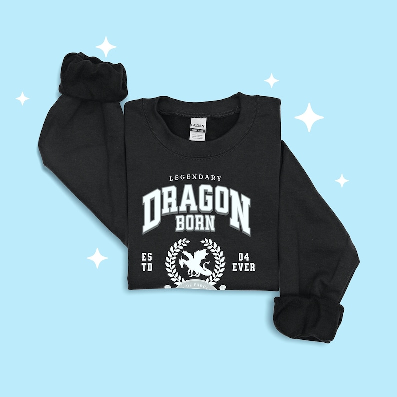 May include: Black sweatshirt with a white graphic design that says "Legendary Dragon Born Est'd 04 Ever" with a dragon silhouette inside a laurel wreath.