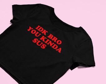 May include: Black cropped t-shirt with red text that reads "IDK bro you kinda sus".
