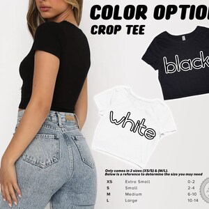 May include: A black and white crop tee shirt with the words "black" and "white" written in a bold, outlined font. The shirt is available in two sizes: XS/S and M/L. A size chart is included with the image.