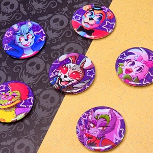 Könnte beinhalten: Sechs runde violette und schwarze Knöpfe mit einem weißen Sternmuster. Jeder Knopf zeigt einen anderen Comic-Charakter mit einem farbenfrohen Design. Die Charaktere umfassen ein blaues und rosa Kaninchen, ein grünes und gelbes Alligator, einen rosa und violetten Wolf, einen rosa und weißen Vogel, einen braunen und gelben Bären und ein rosa und weißes Kaninchen.