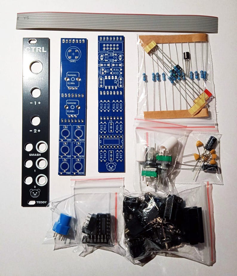 May include: An assortment of electronic components, including circuit boards, resistors, capacitors, and potentiometers. The image features a black panel with the text "CTRL" and "SMASH", along with other components in clear plastic bags. A ribbon cable is at the top.