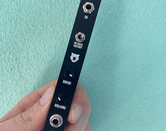 May include: Black metal pedal with the text "CRNCH" and knobs labeled "IN", "HI FREQ CUTOFF", "DRIVE", "VOLUME", and "OUT".