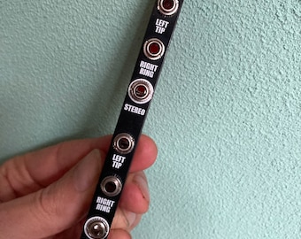 May include: Black metal panel with the word "SPLIT" printed in white. The panel has six jacks with labels: "LEFT TIP", "RIGHT RING", "STEREO", "LEFT TIP", "RIGHT RING", and "STEREO".