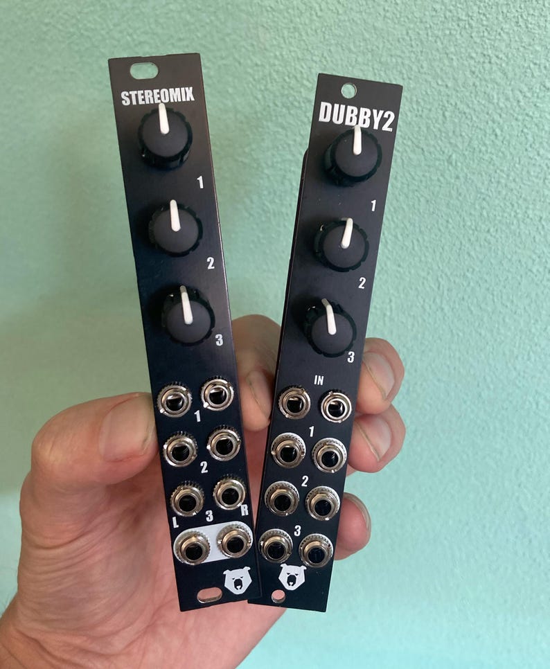May include: Two black audio effect modules with knobs and jacks. The module on the left is labeled "STEREOMIX" and the module on the right is labeled "DUBBY2".