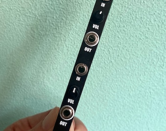May include: Black metal audio module with the text "AMPY" and two sets of input and output jacks, labeled "IN", "VOL", and "OUT".