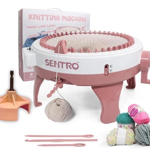 May include: A pink and white Sentro knitting machine with a crank, needles, and yarn. The box behind the machine reads "Knitting Machine" and "Magic Loop Loom". Additional accessories include a yarn winder and several skeins of colorful yarn.