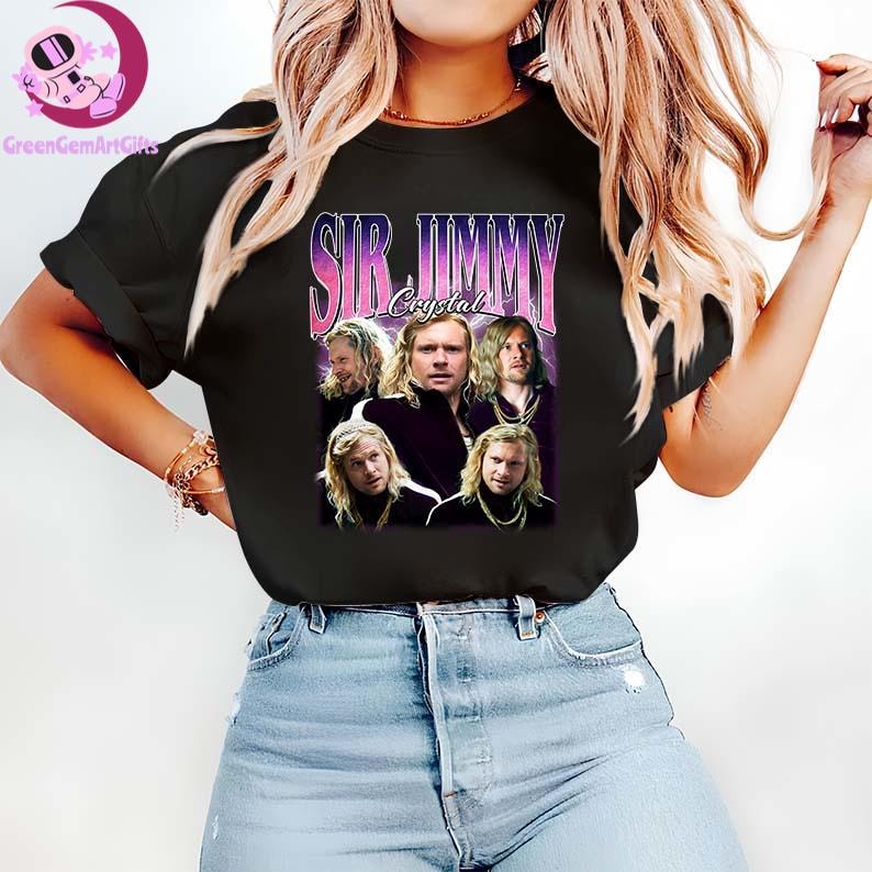May include: Black t-shirt featuring a graphic of a man with long blonde hair, with the text "SIR JIMMY Crystal" in a retro style. The shirt is worn by a person in blue jeans.