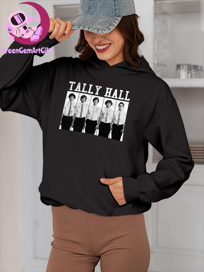 May include: Black hoodie featuring the text "TALLY HALL" above a black and white image of five people. The hoodie has a front pocket and a drawstring hood. The sleeves are long and the material appears to be a soft fabric.