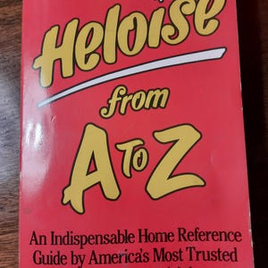 May include: A red book with the title "Heloise from A to Z" in yellow letters. The book is a home reference guide by America's Most Trusted Household-Hints Advisor.